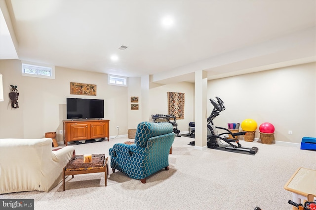 living area with light carpet, visible vents, and baseboards