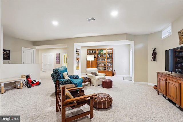 living room featuring visible vents, baseboards, and carpet floors