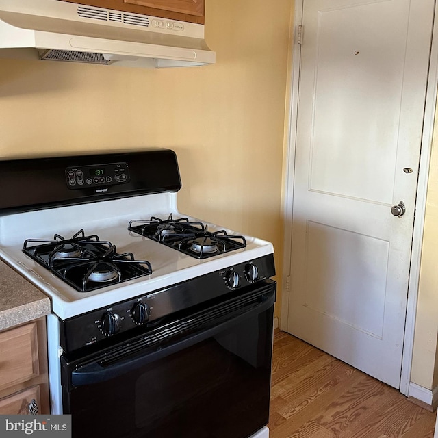 kitchen featuring gas stove and light hardwood / wood-style floors