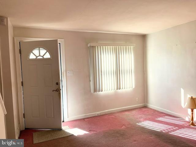 entryway featuring light carpet