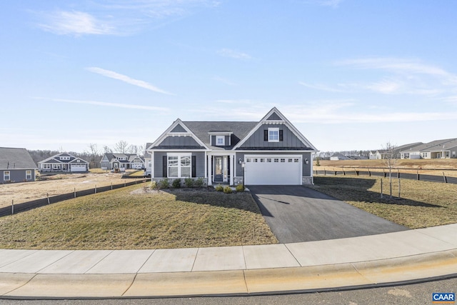 craftsman-style house featuring a garage and a front lawn