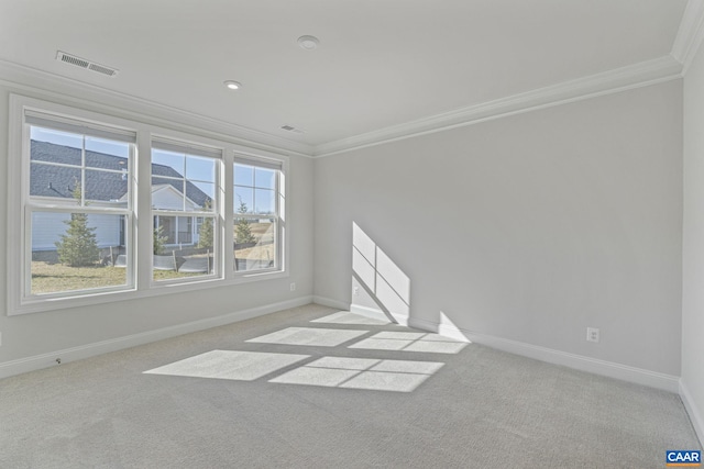 empty room featuring light carpet and ornamental molding