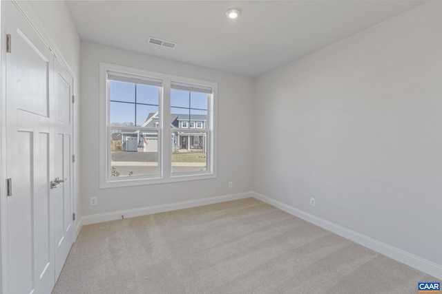 unfurnished room with light colored carpet