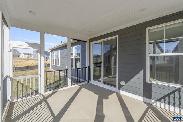 unfurnished sunroom with a wealth of natural light