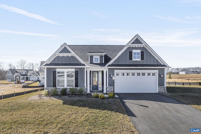 view of front of house featuring a garage and a front lawn