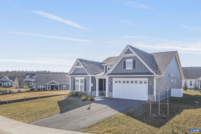 view of front of house with a garage and a front lawn