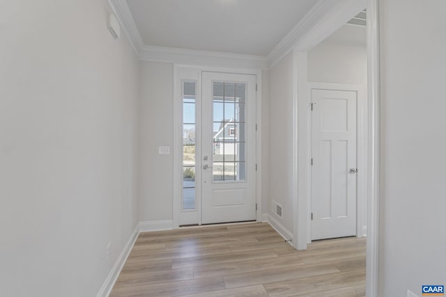 entryway with ornamental molding and light wood-type flooring