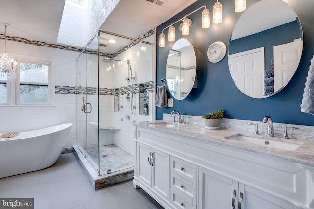 bathroom with tile patterned floors, shower with separate bathtub, and vanity