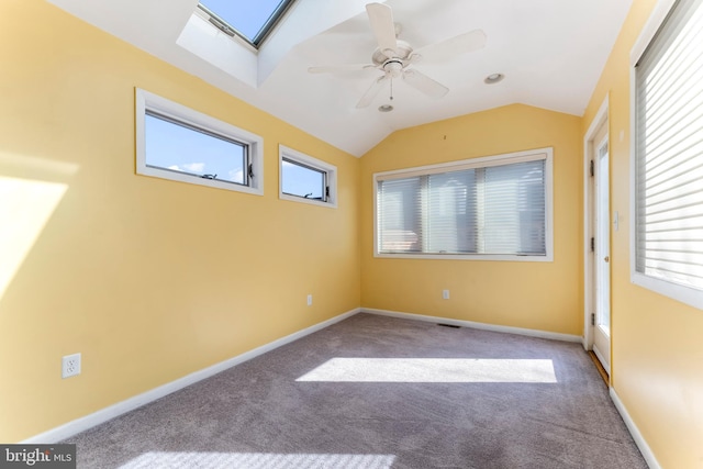 empty room featuring carpet floors, vaulted ceiling, and ceiling fan