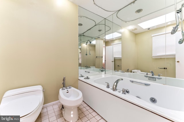 bathroom with a bidet, a tub to relax in, tile patterned floors, and toilet