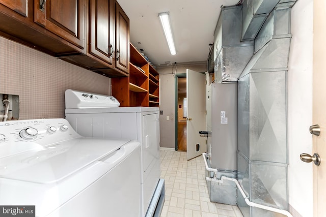 laundry area with heating unit, cabinets, and washing machine and clothes dryer