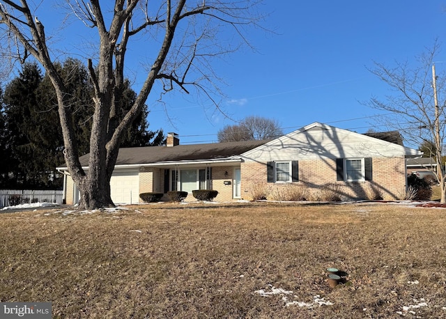 ranch-style house with a garage and a front lawn