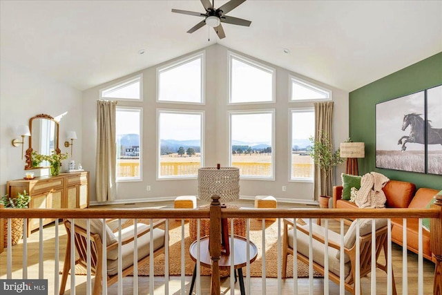 sunroom / solarium with lofted ceiling, a mountain view, and a healthy amount of sunlight