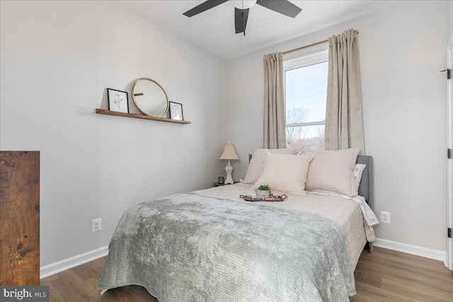 bedroom featuring ceiling fan and dark hardwood / wood-style floors