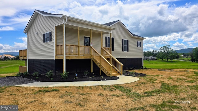 1390 Rivermont Dr, Front Royal, VA 22630 - view of front of house featuring stairway, a front yard, and covered porch
