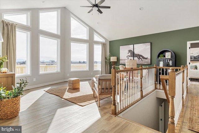 interior space with lofted ceiling and ceiling fan