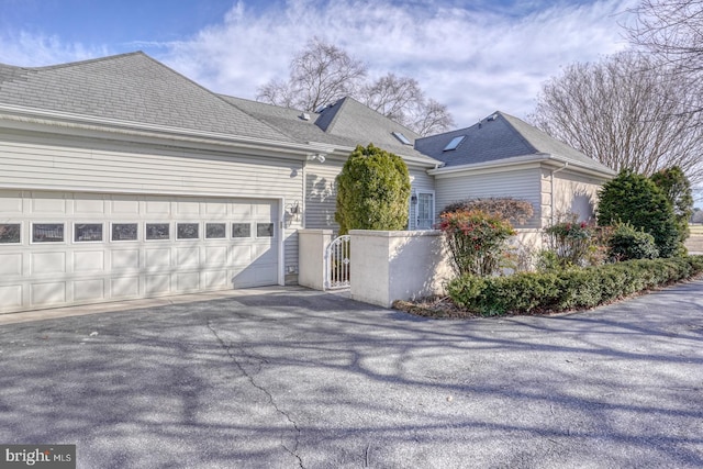 view of side of home featuring a garage