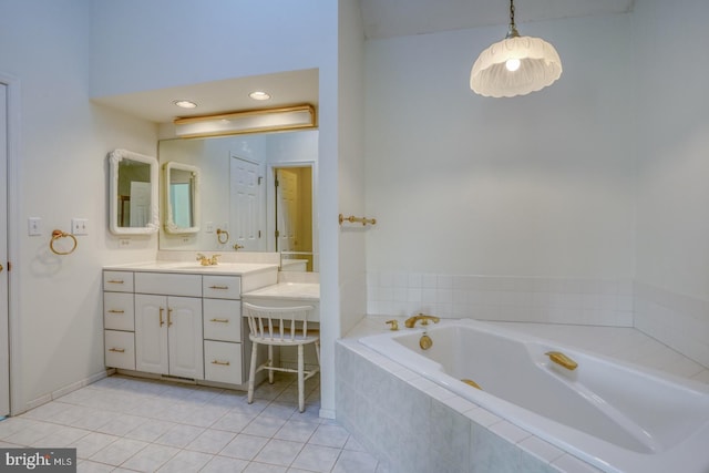 bathroom with tile patterned flooring, vanity, and a relaxing tiled tub