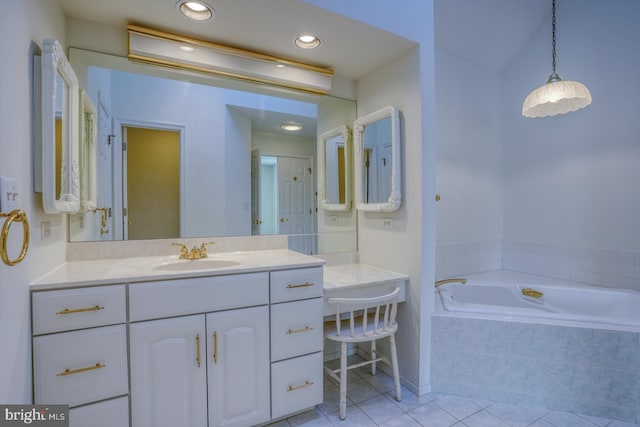 bathroom featuring vanity, tiled bath, and tile patterned flooring