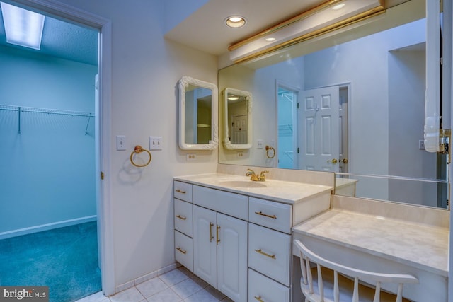 bathroom featuring tile patterned flooring and vanity