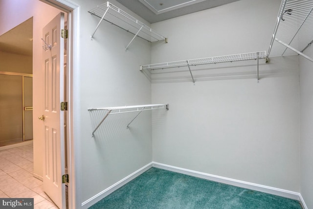 spacious closet with tile patterned floors