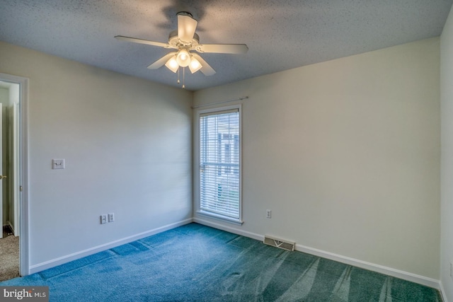 carpeted spare room featuring ceiling fan and a textured ceiling