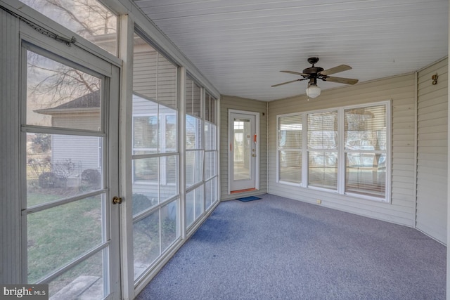 unfurnished sunroom featuring ceiling fan