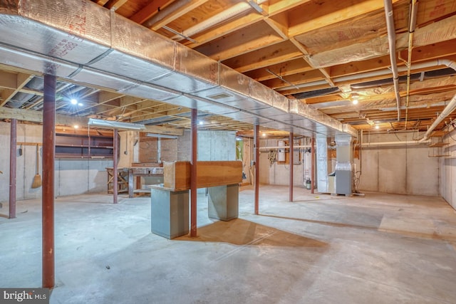 basement with water heater and heating unit