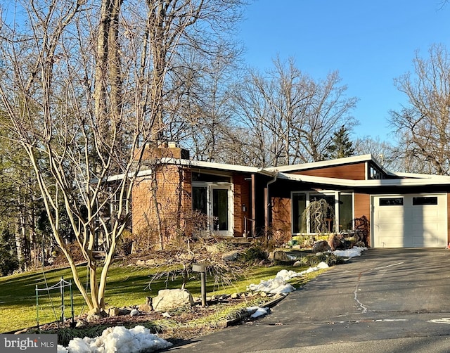 view of front of property with a garage and a front yard