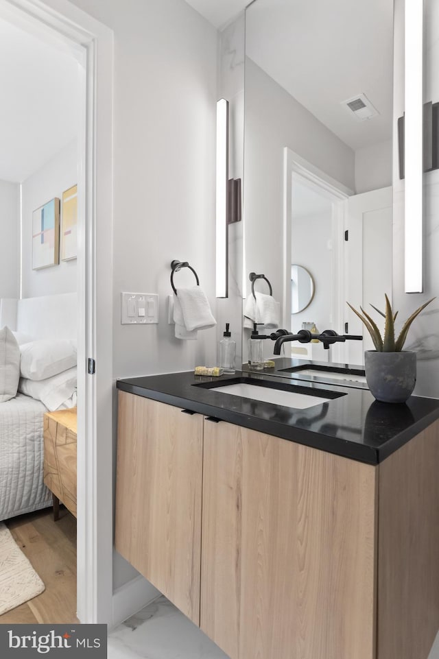 bathroom featuring vanity and hardwood / wood-style flooring