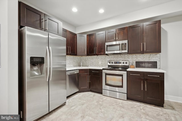 kitchen featuring stainless steel appliances, sink, dark brown cabinetry, and decorative backsplash