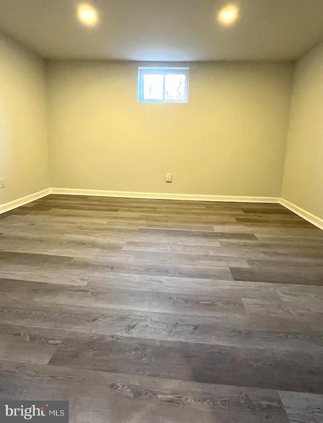 basement with dark hardwood / wood-style flooring