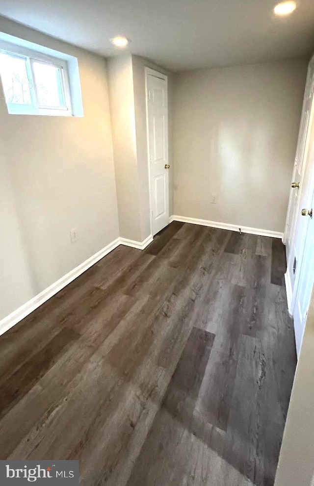 unfurnished bedroom with dark hardwood / wood-style flooring