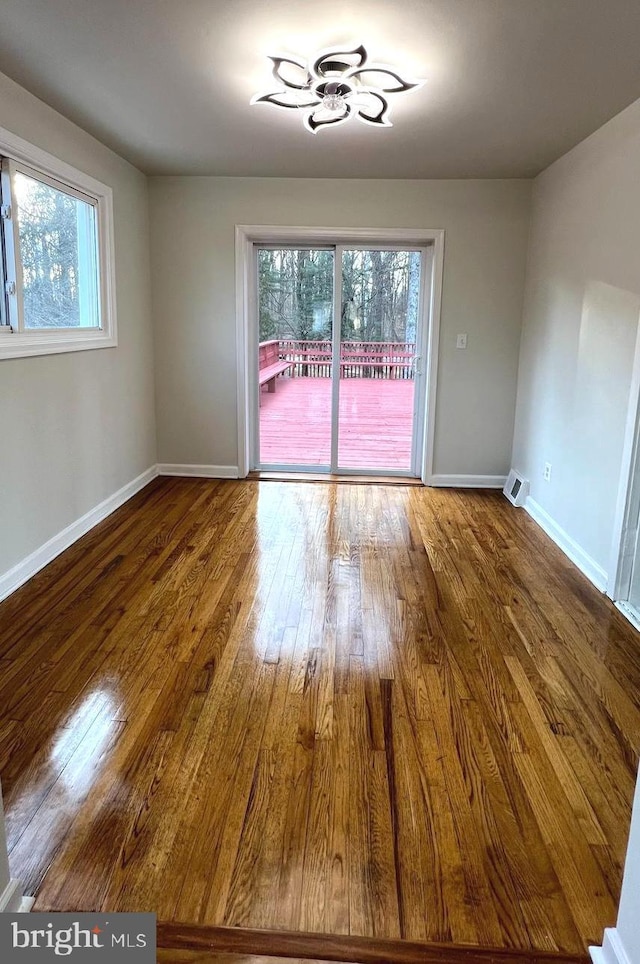 unfurnished dining area featuring hardwood / wood-style flooring and plenty of natural light