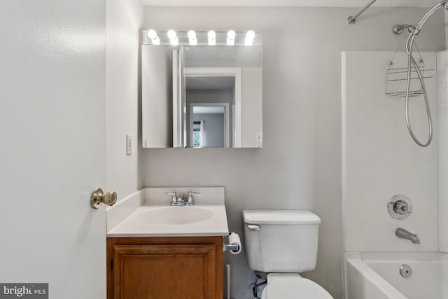 full bathroom featuring washtub / shower combination, vanity, and toilet