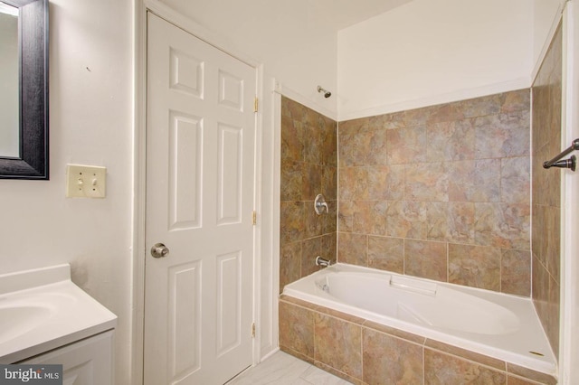 bathroom with vanity and tiled shower / bath combo