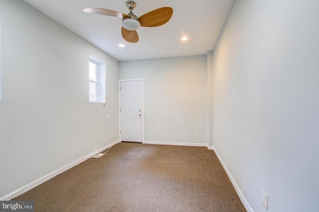 carpeted spare room featuring ceiling fan