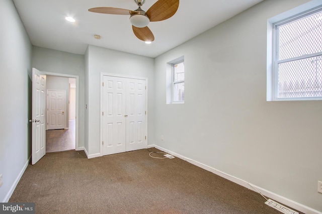 unfurnished bedroom with a closet, ceiling fan, and carpet