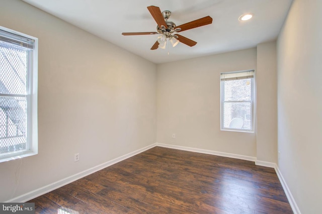 unfurnished room with dark hardwood / wood-style floors and ceiling fan