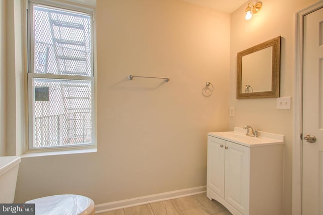 bathroom featuring vanity, toilet, and a wealth of natural light