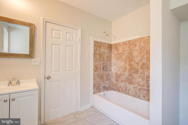 bathroom featuring tiled shower / bath combo and vanity