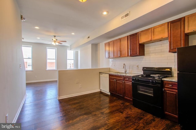 kitchen with black appliances, sink, dark hardwood / wood-style flooring, decorative backsplash, and kitchen peninsula