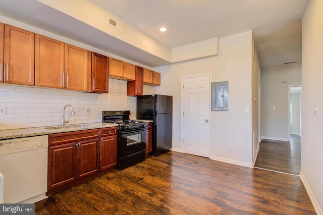 kitchen with sink, backsplash, light stone counters, black appliances, and dark hardwood / wood-style flooring