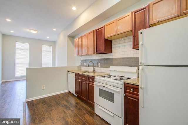 kitchen featuring sink, white appliances, backsplash, dark hardwood / wood-style floors, and light stone countertops