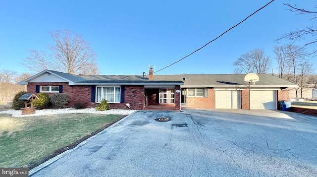 ranch-style home with a garage and a front yard