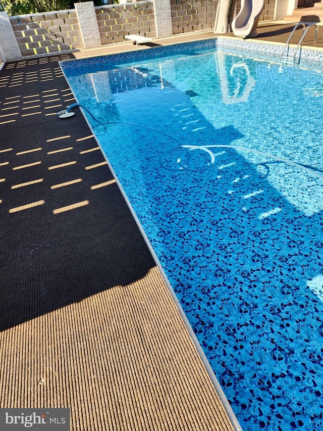 view of pool with a water slide