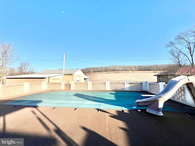 view of swimming pool featuring a water slide