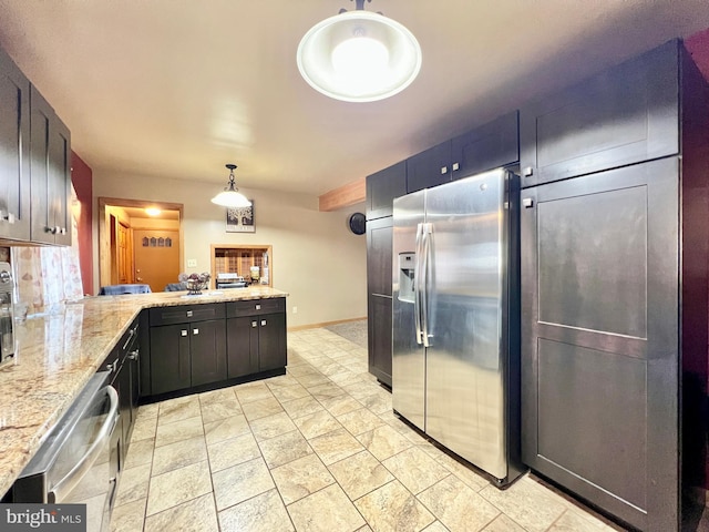 kitchen featuring pendant lighting, dishwashing machine, stainless steel fridge, kitchen peninsula, and light stone countertops