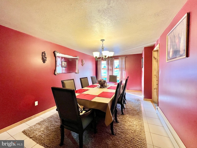 dining room featuring baseboard heating, a notable chandelier, a textured ceiling, and light tile patterned floors