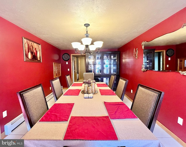 dining area with baseboard heating, a chandelier, a textured ceiling, and light tile patterned floors